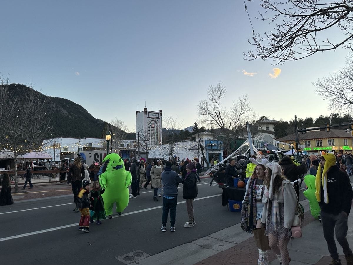 Costumed visitors on Elkhorn Avenue with the Park Theatre in the background.