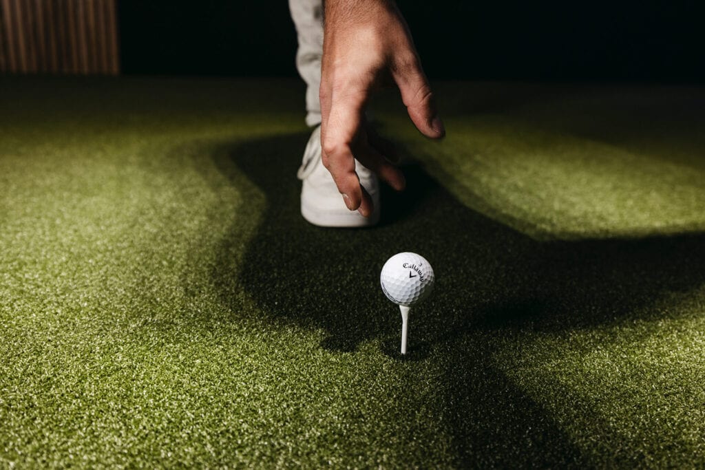 A golf ball on a tee in Paddle + Par’s promotional golf photograph