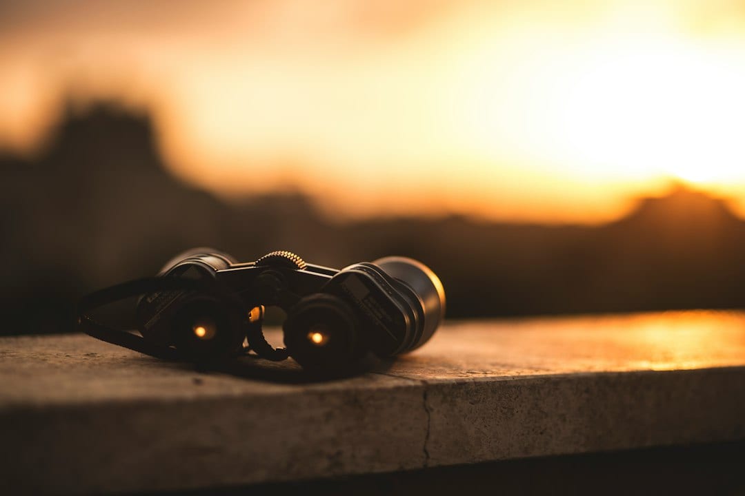 Illustrative stock photo showing a close-up view of black binoculars
