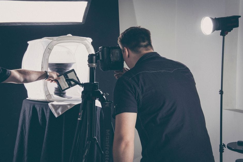 Illustrative stock photo of a photographer working with studio lighting and a camera, not a Champaign-Urbana provider or SBDC session.