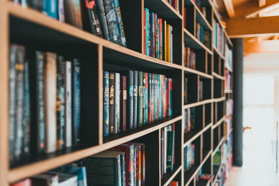 Illustrative stock photo of colorful books arranged on library shelves, not Champaign Public Library.