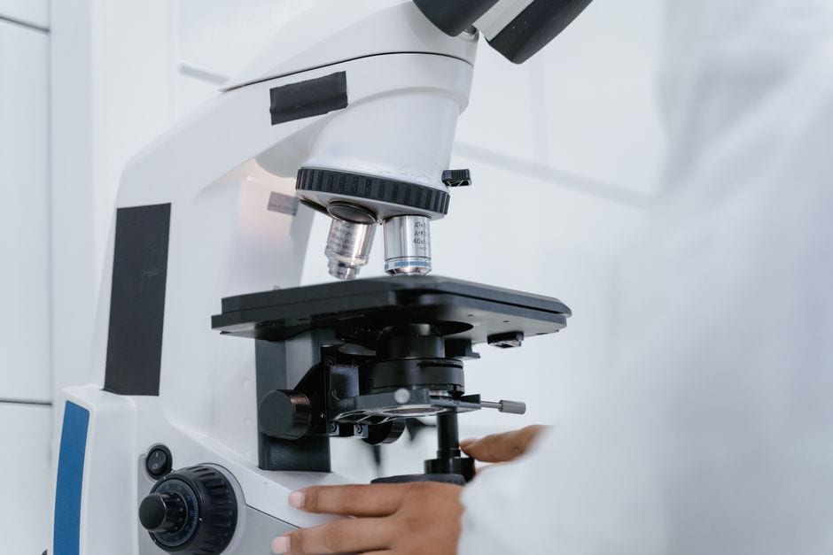 Scientist using a microscope, illustrative stock photo, not the Urbana event