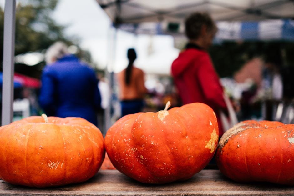 Pumpkins displayed at an outdoor farmers market
